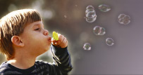 Boy blowing bubbles
