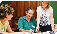 Staff discussing the MoneyMinded training sessions