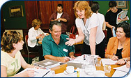 Staff discussing the MoneyMinded training sessions