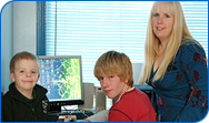 Julie and her sons with their new computer 