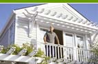 Man standing on the balcony of a house