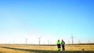 Windfarm with two workers in hard hats