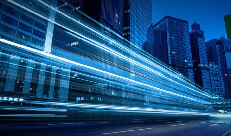 Traffic lights passing by in a blue cityscape